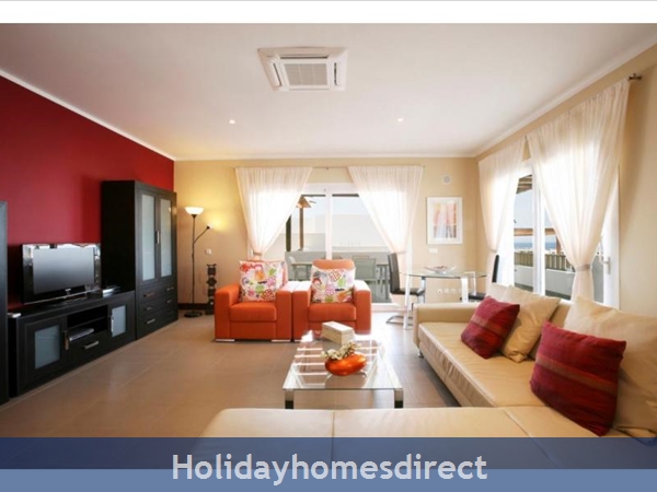 Villa Calero indoor sitting room with a tv